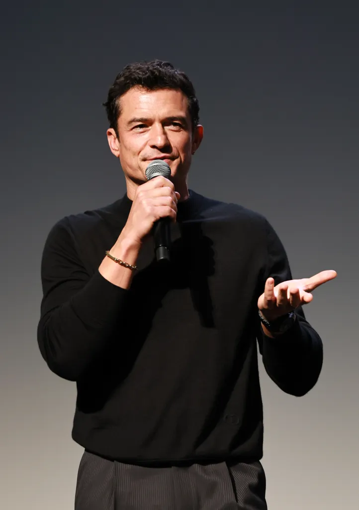 Orlando Bloom speaking onstage at the 