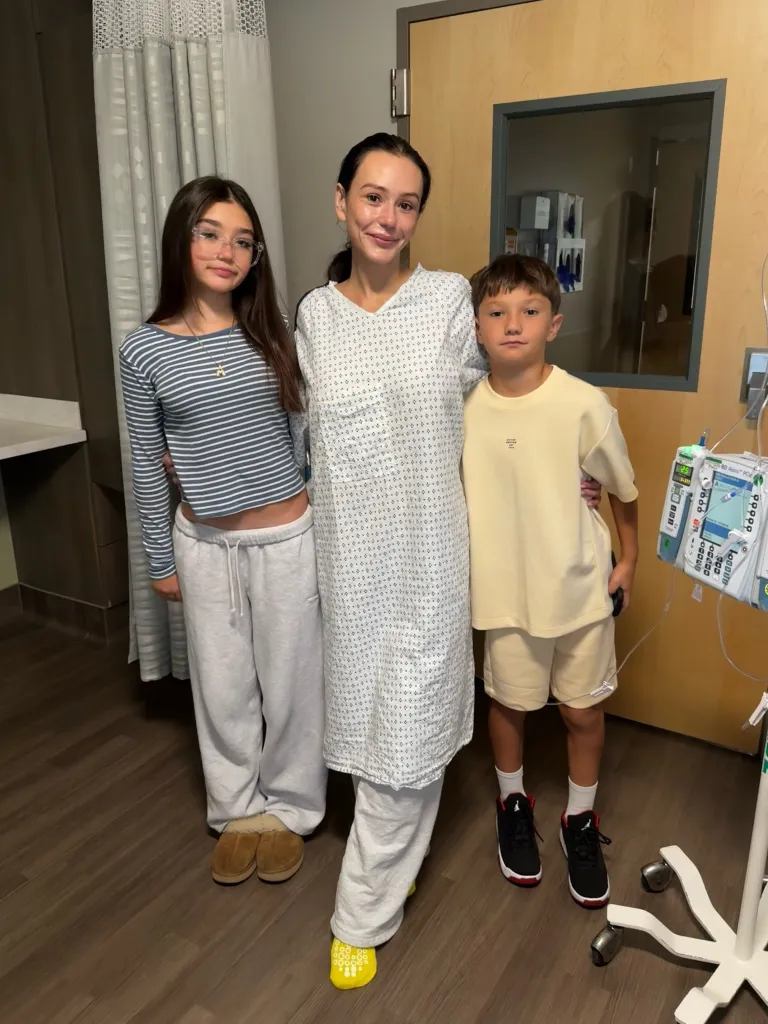 Jenni Farley (JWoww) posing in a hospital gown with her two children.