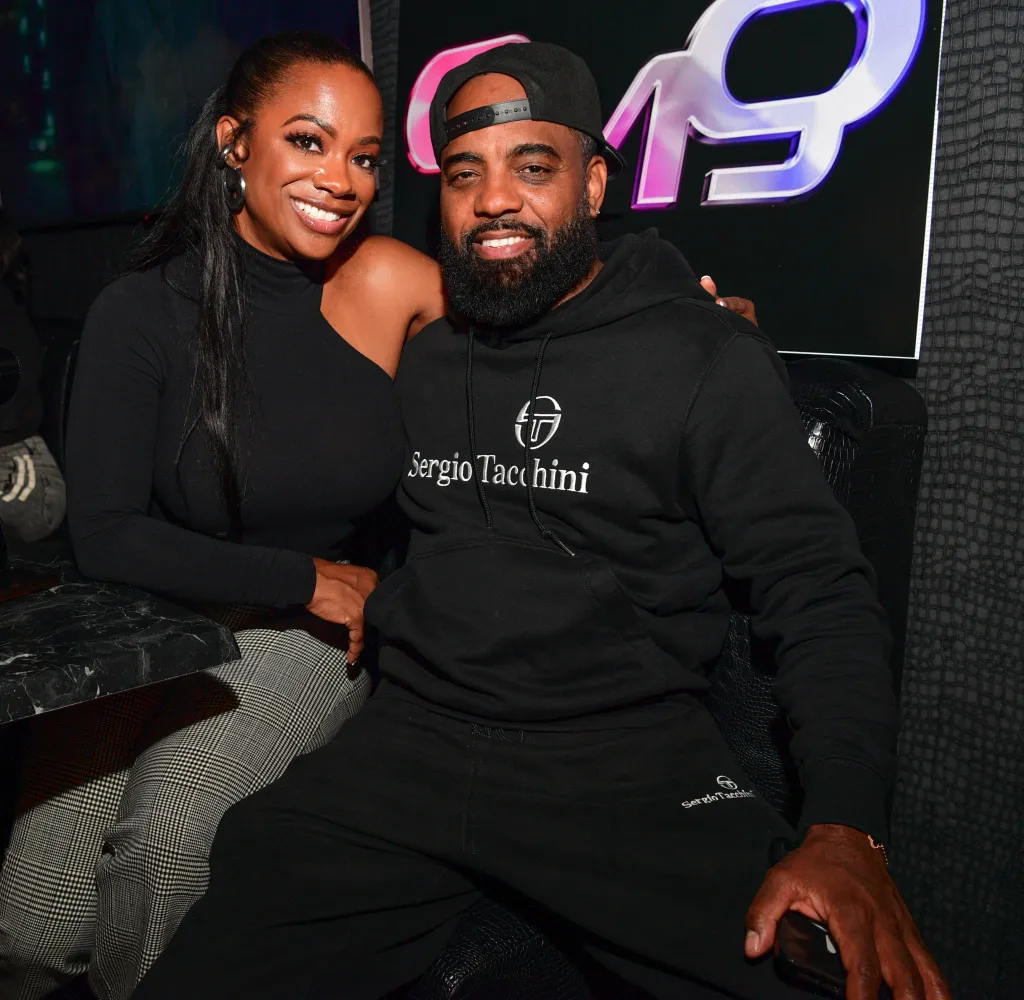 Kandi Burruss and Todd Tucker seated at a table.