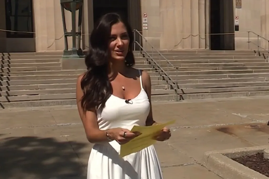 Katrina Badowski holding her jury duty summons while standing outside the Wyandotte County Courthouse.