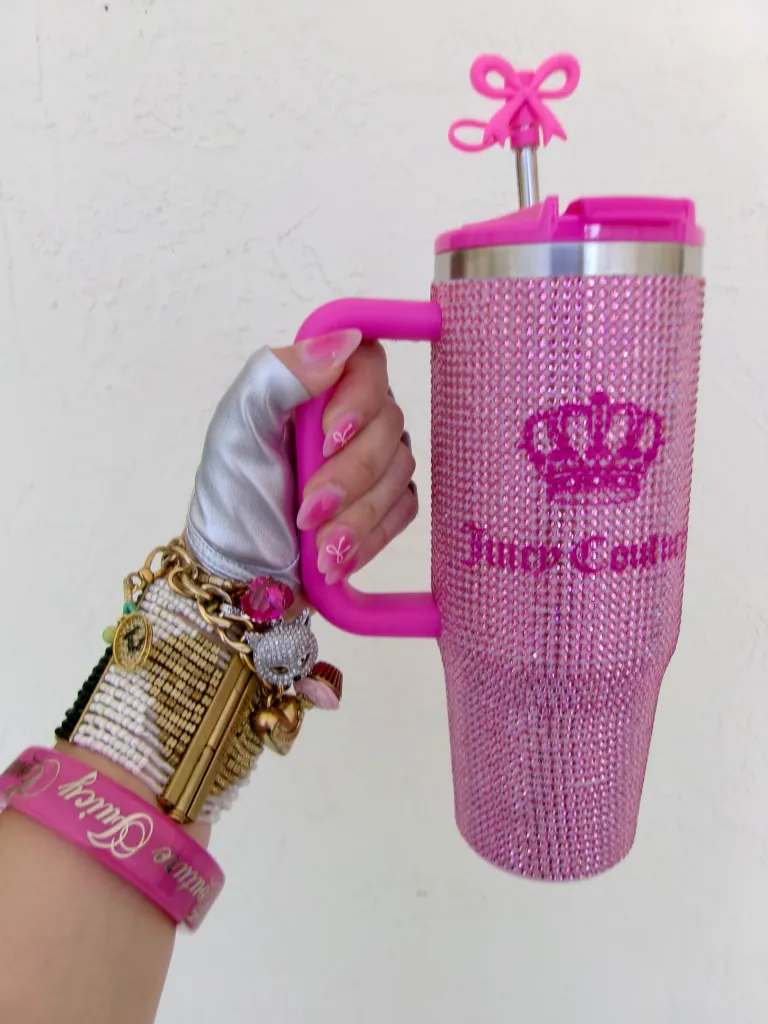 Katerina Kladis holds a pink rhinestone-covered Juicy Couture tumbler, showcasing a 