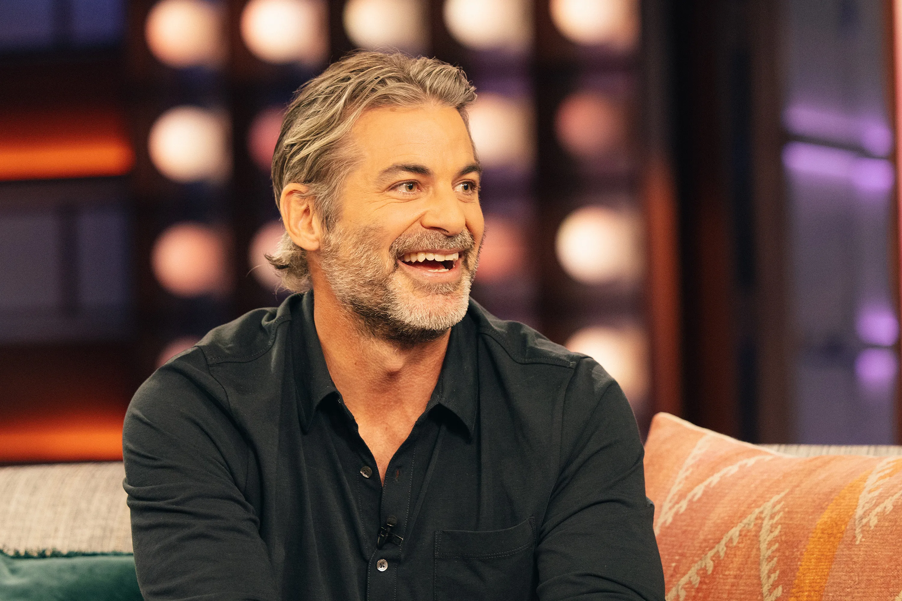 Jim Curtis smiling while being interviewed on The Kelly Clarkson Show.