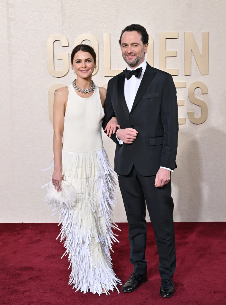 Keri Russell, in a white gown, and Matthew Rhys, in a black tuxedo, attend the 81st Annual Golden Globe Awards.