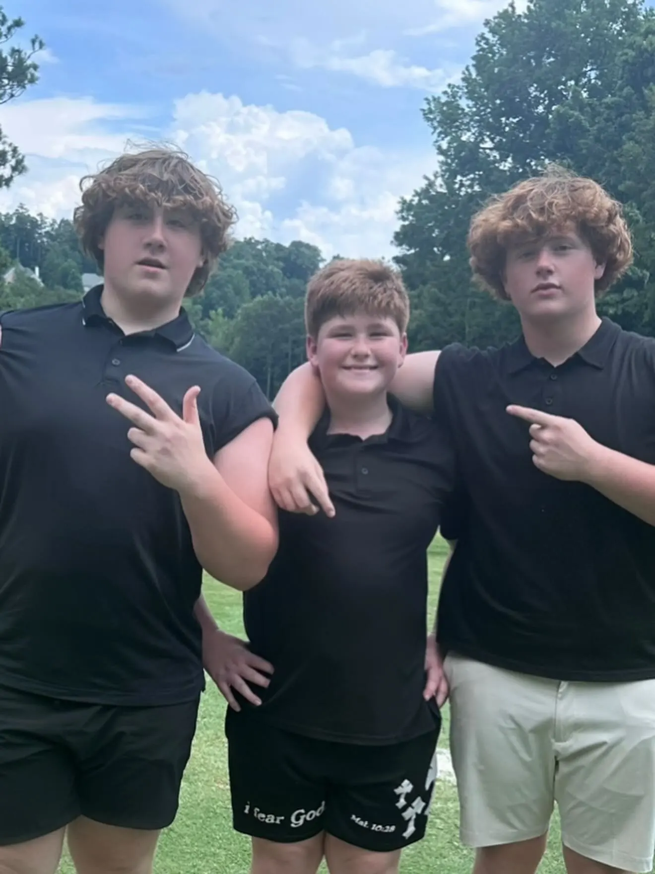 KJ Biermann with his two brothers, posing for a photo.
