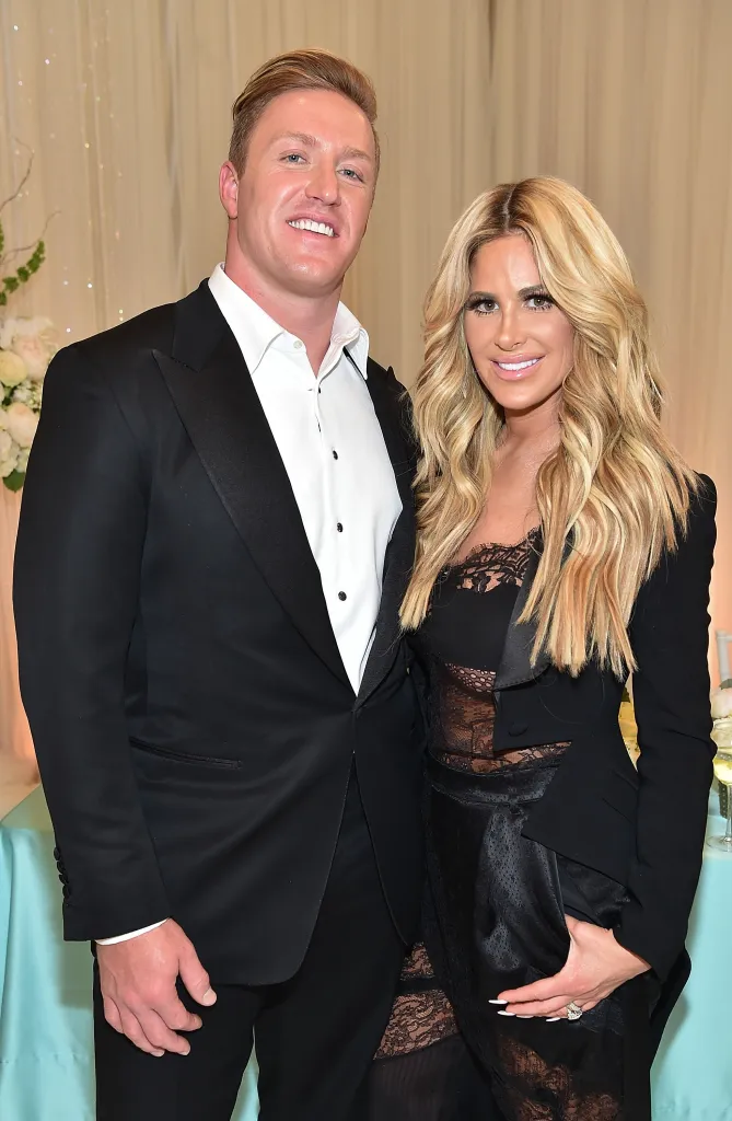 Kroy Biermann and Kim Zolciak-Biermann smile at a birthday party.