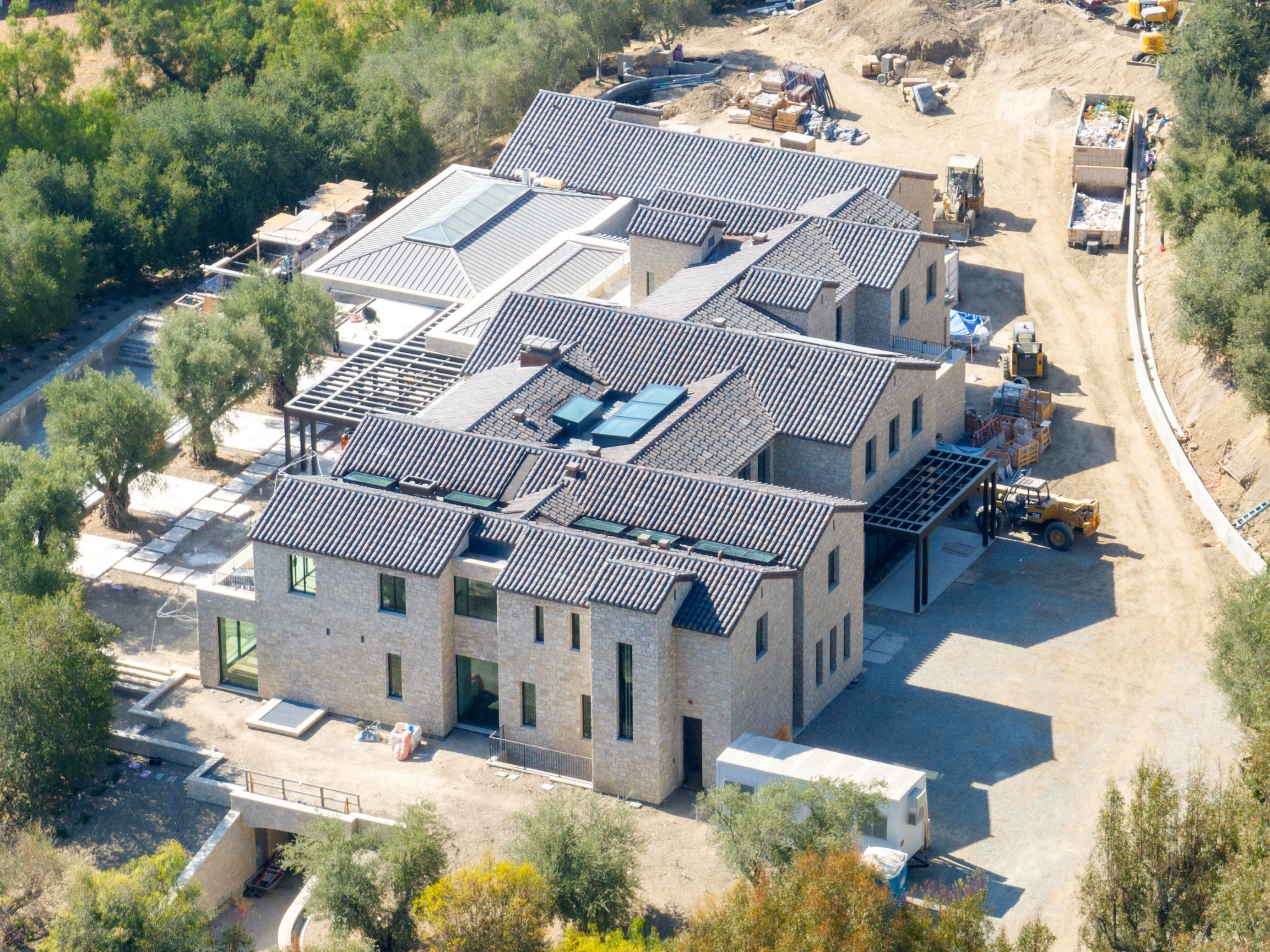 Aerial view of Kylie Jenner's Hidden Hills mega-mansion nearing completion, with construction equipment and materials visible around the property.