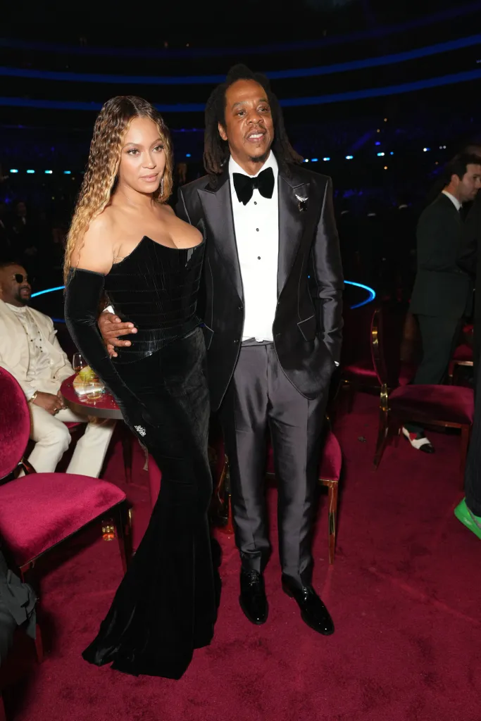 Beyoncé and Jay-Z standing on a red carpet at the 65th GRAMMY Awards.