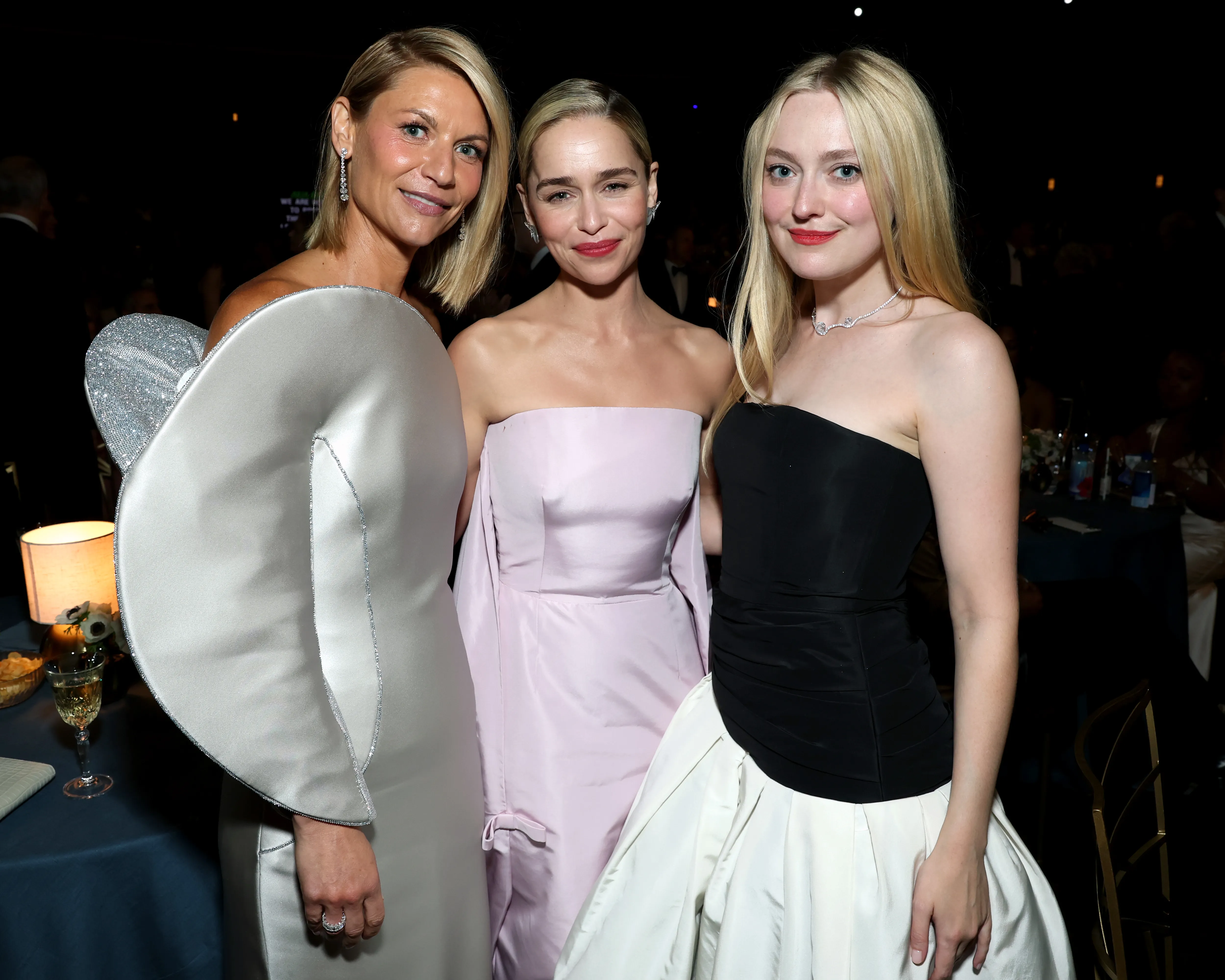 Claire Danes, Emilia Clarke, and Dakota Fanning posing together.