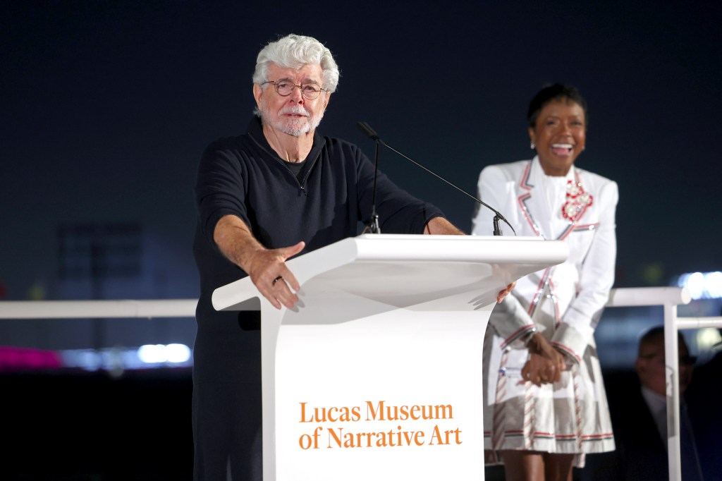 George Lucas speaking at a podium with 