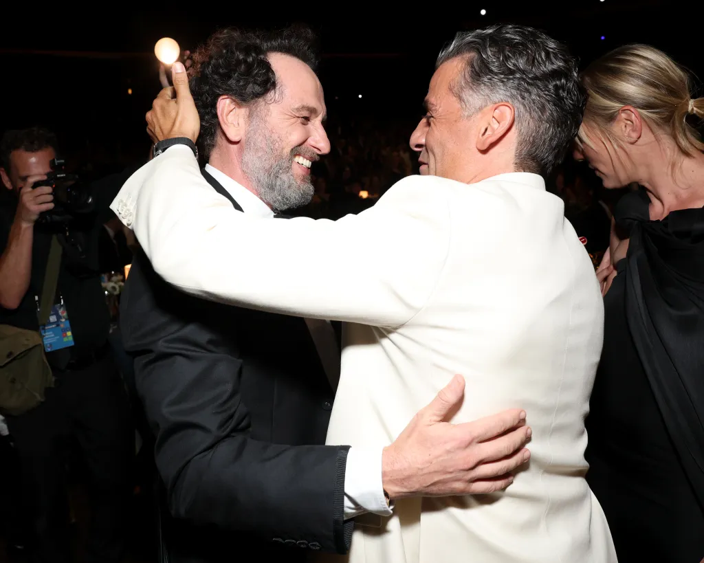 Matthew Rhys and Oscar Isaac embracing.