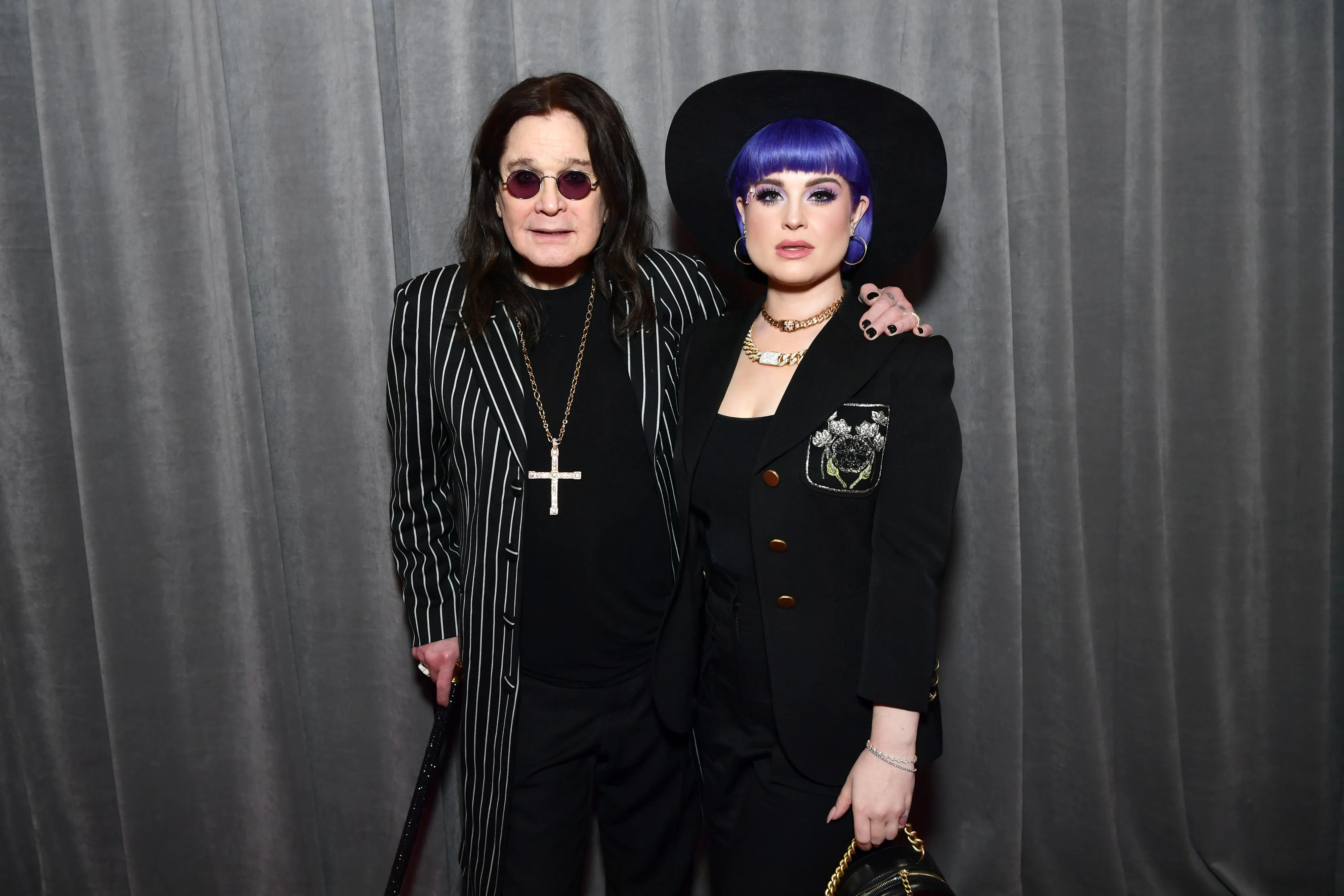 Ozzy Osbourne and Kelly Osbourne pose on the red carpet.