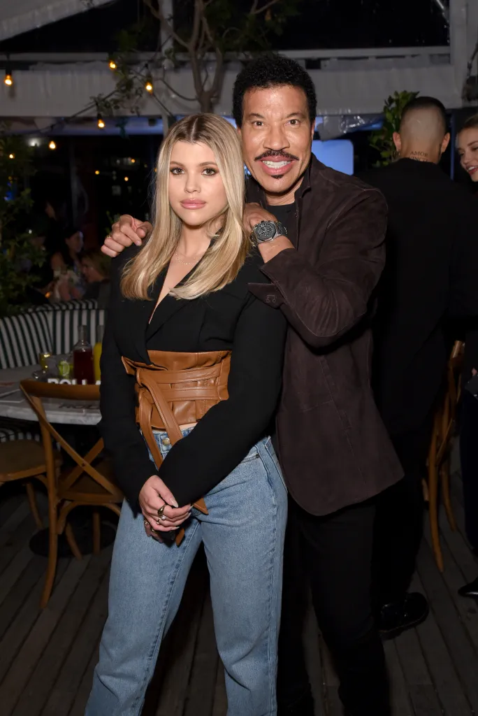 Sofia Richie and Lionel Richie posing together at the Rolla's x Sofia Richie Launch Event.