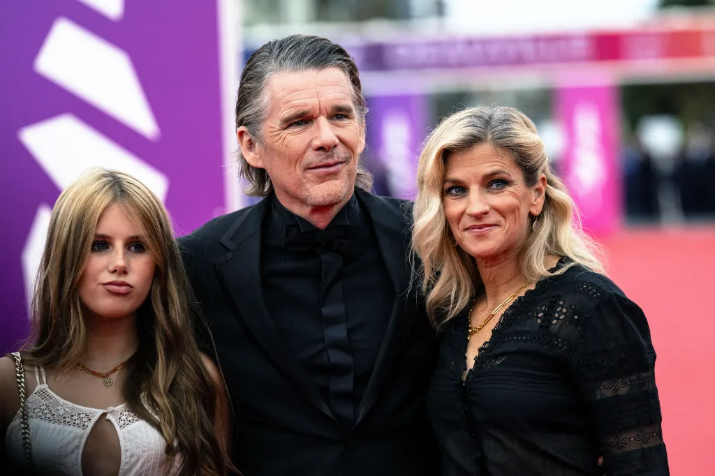 Ethan Hawke poses with his daughter Clementine Jane Hawke and wife Ryan Hawke on the red carpet.