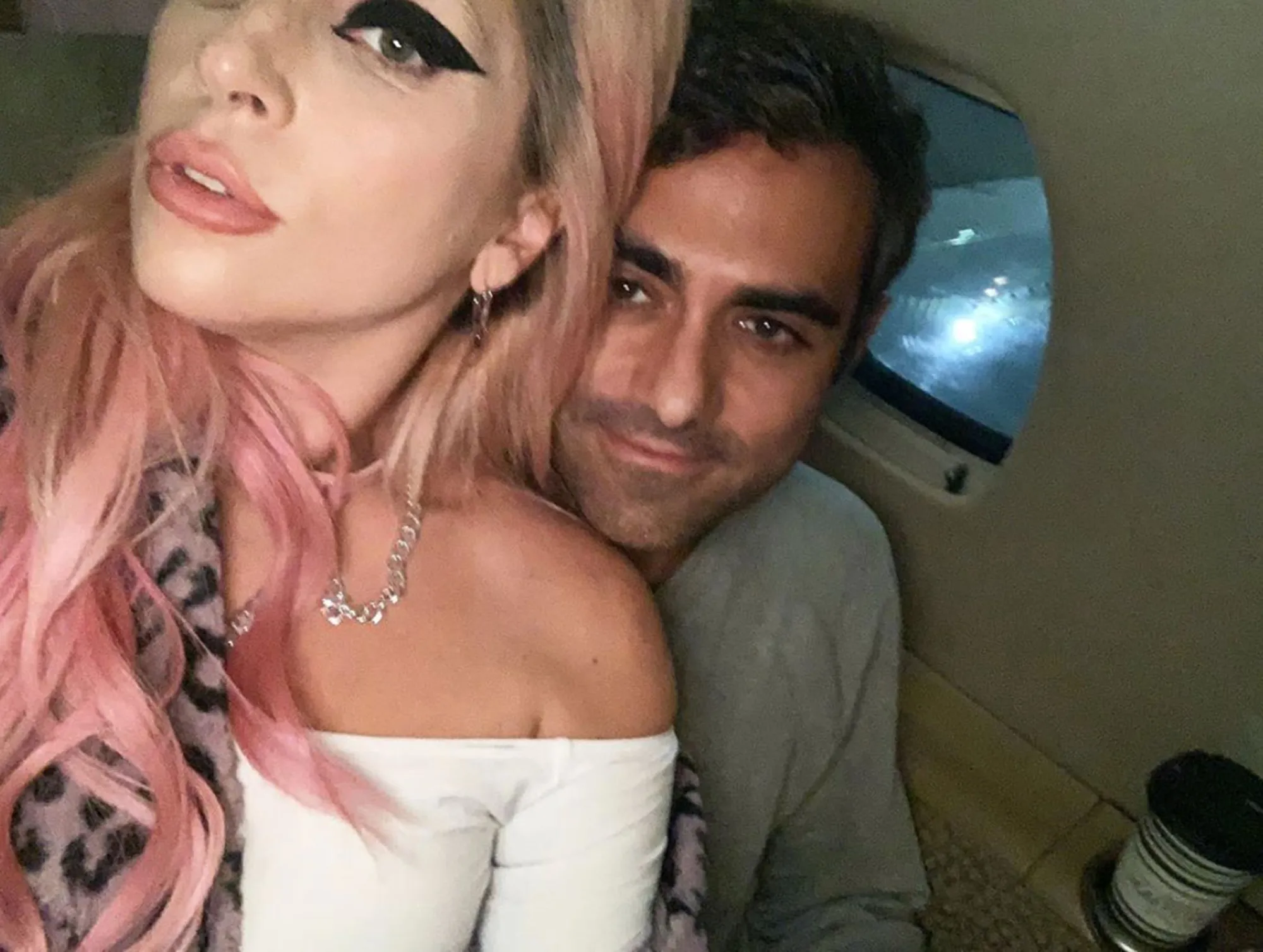 Lady Gaga and Michael Polansky in an airplane, with Lady Gaga looking towards the camera.