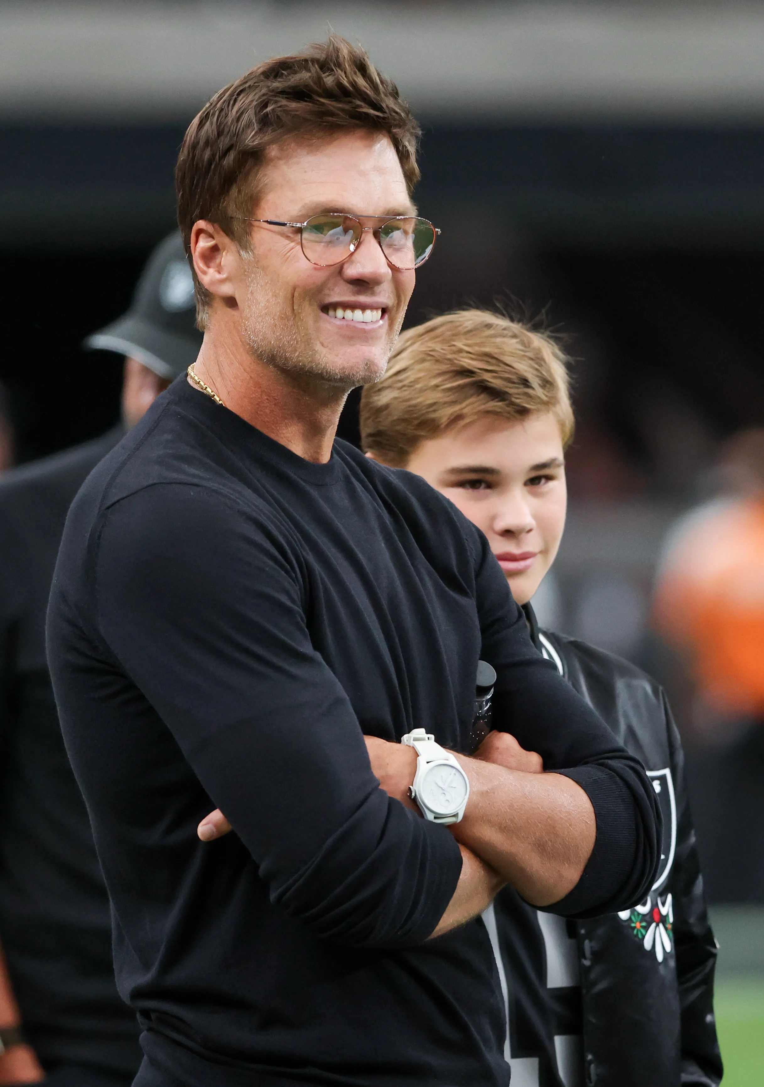 Las Vegas Raiders minority owner Tom Brady smiling at a preseason game.