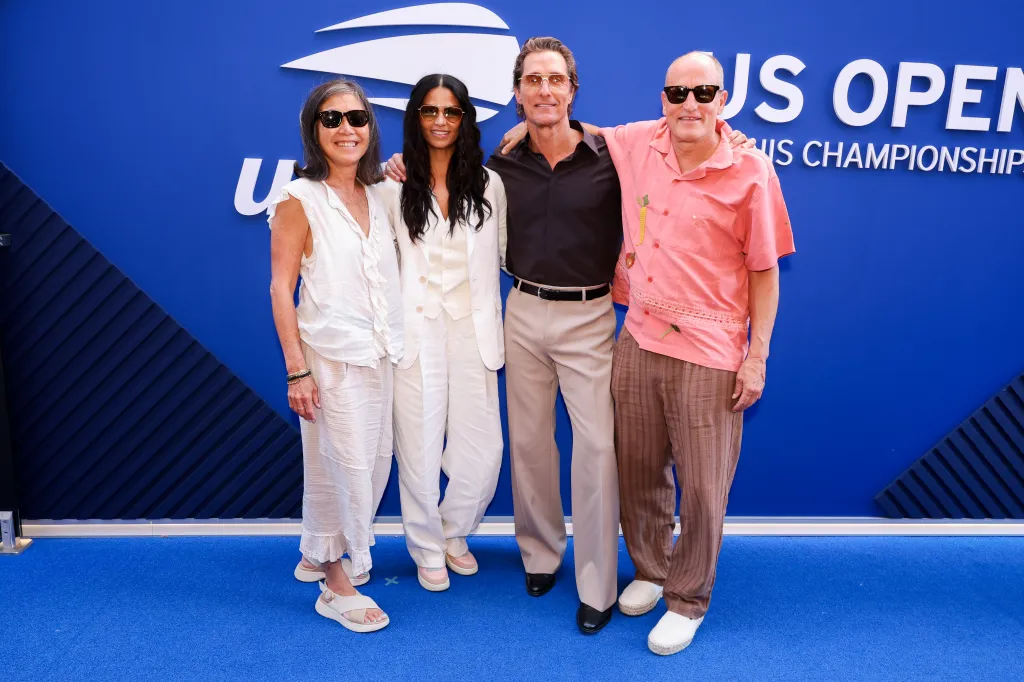 Laura Louie, Camila Alves, Matthew McConaughey, and Woody Harrelson pose on the blue carpet during the 2026 US Open.