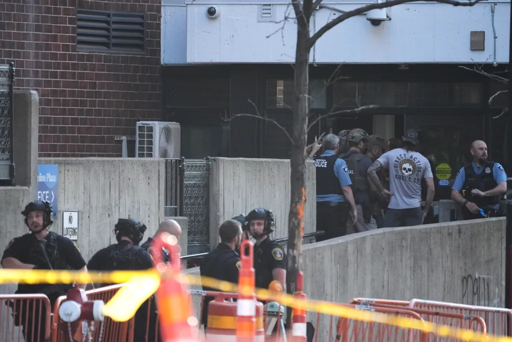 Law enforcement officers responding to a shooting in downtown Minneapolis.