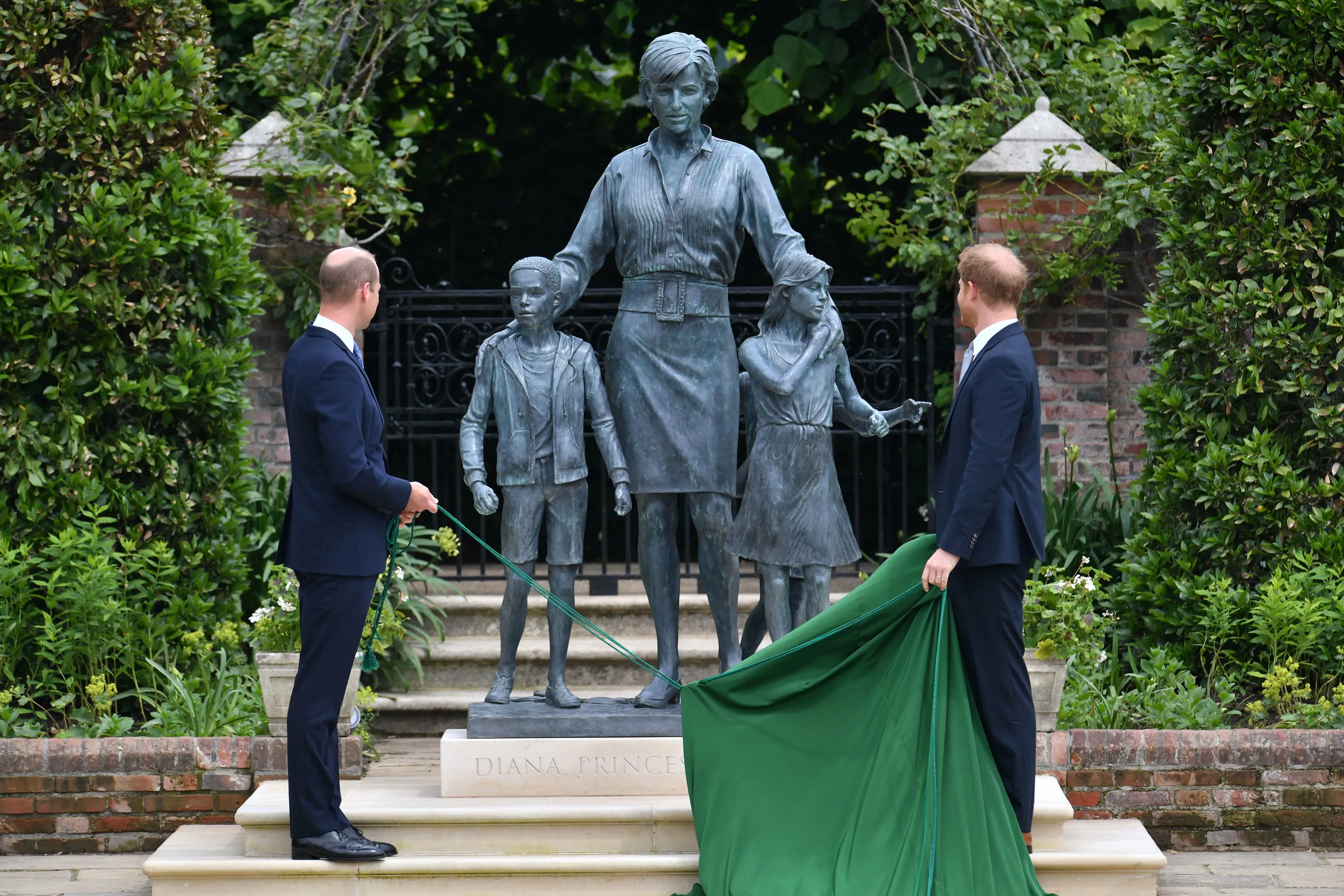 Prince William and Prince Harry unveil a statue of their mother, Diana, Princess of Wales, in the Sunken Garden at Kensington Palace.