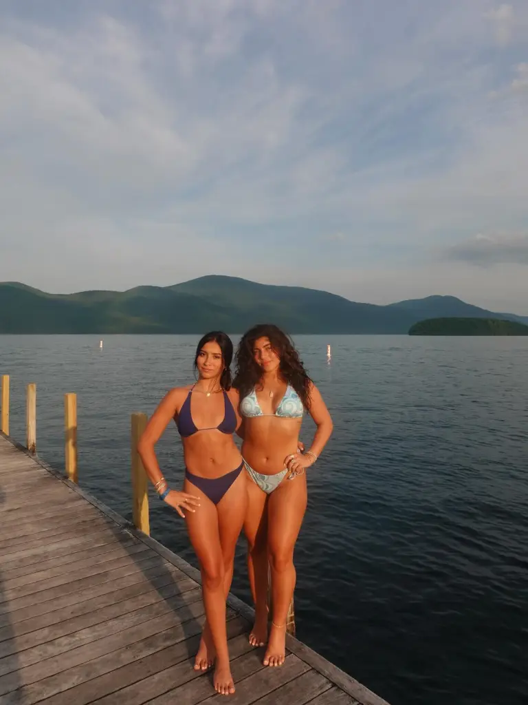 Milania Giudice (right) and Victoria Zardoya (left) pose on a dock at Lake George.