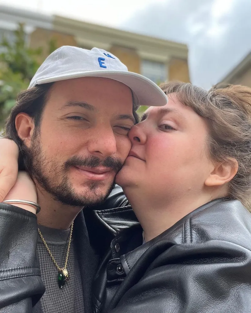 Lena Dunham kissing Attawalpa on the cheek.