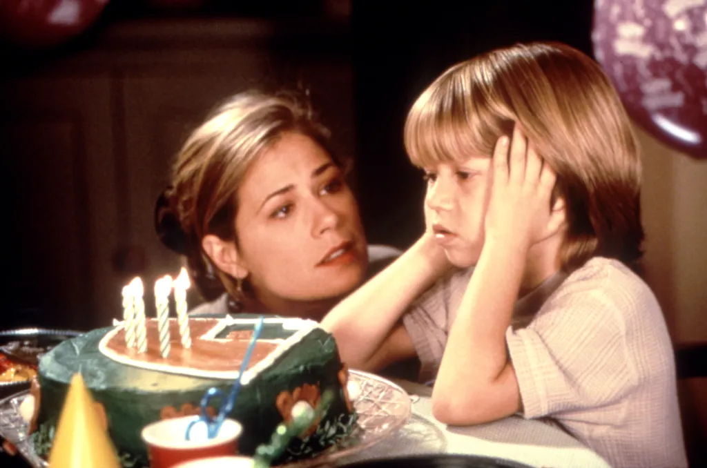 Maura Tierney as Audrey Reede and Justin Cooper as Max Reede at a birthday party from the film Liar Liar.