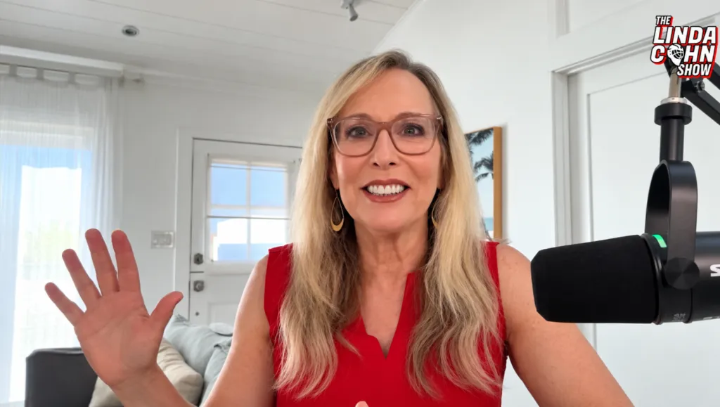 Linda Cohn smiling and waving during an episode of The Linda Cohn Show.