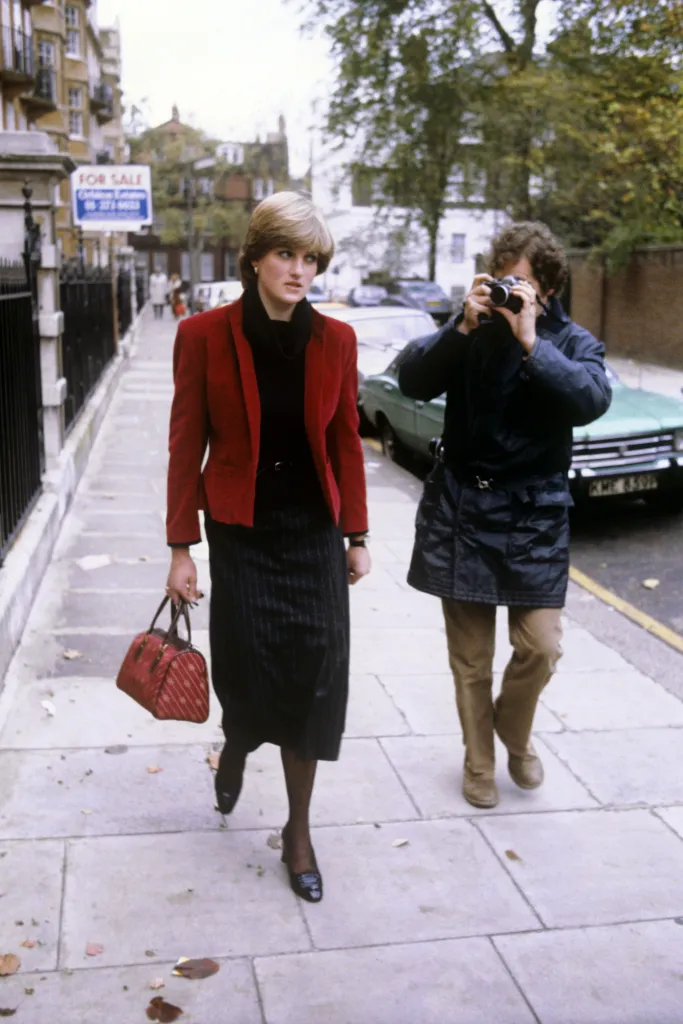 Lady Diana Spencer being photographed by the press on a London street.