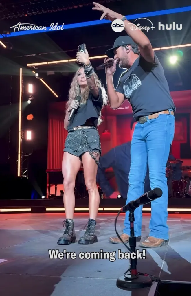 Carrie Underwood taking a selfie with Luke Bryan on the American Idol stage.