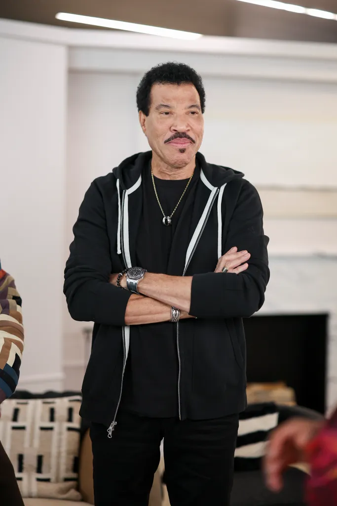 Lionel Richie wearing a black zipped hoodie and black shirt.