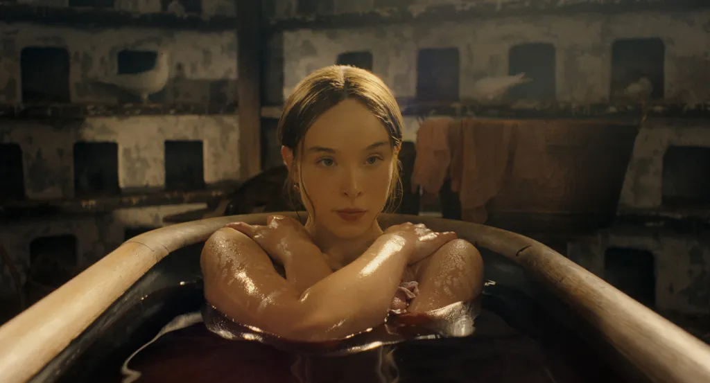 Ella Beatty as Lizzie Borden bathing in a tub for the television series,