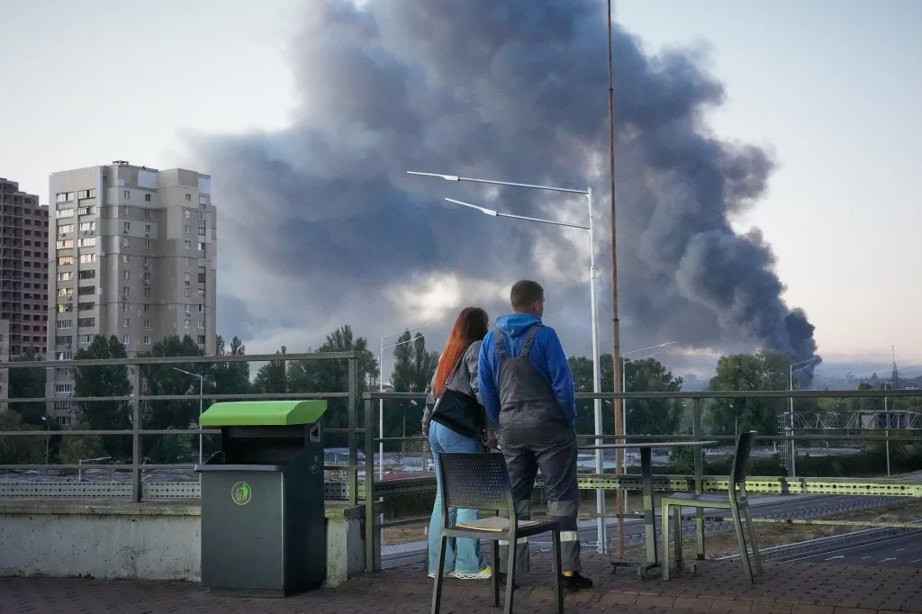 Local residents watch large plumes of smoke after a Russian missile attack in Kyiv, Ukraine.