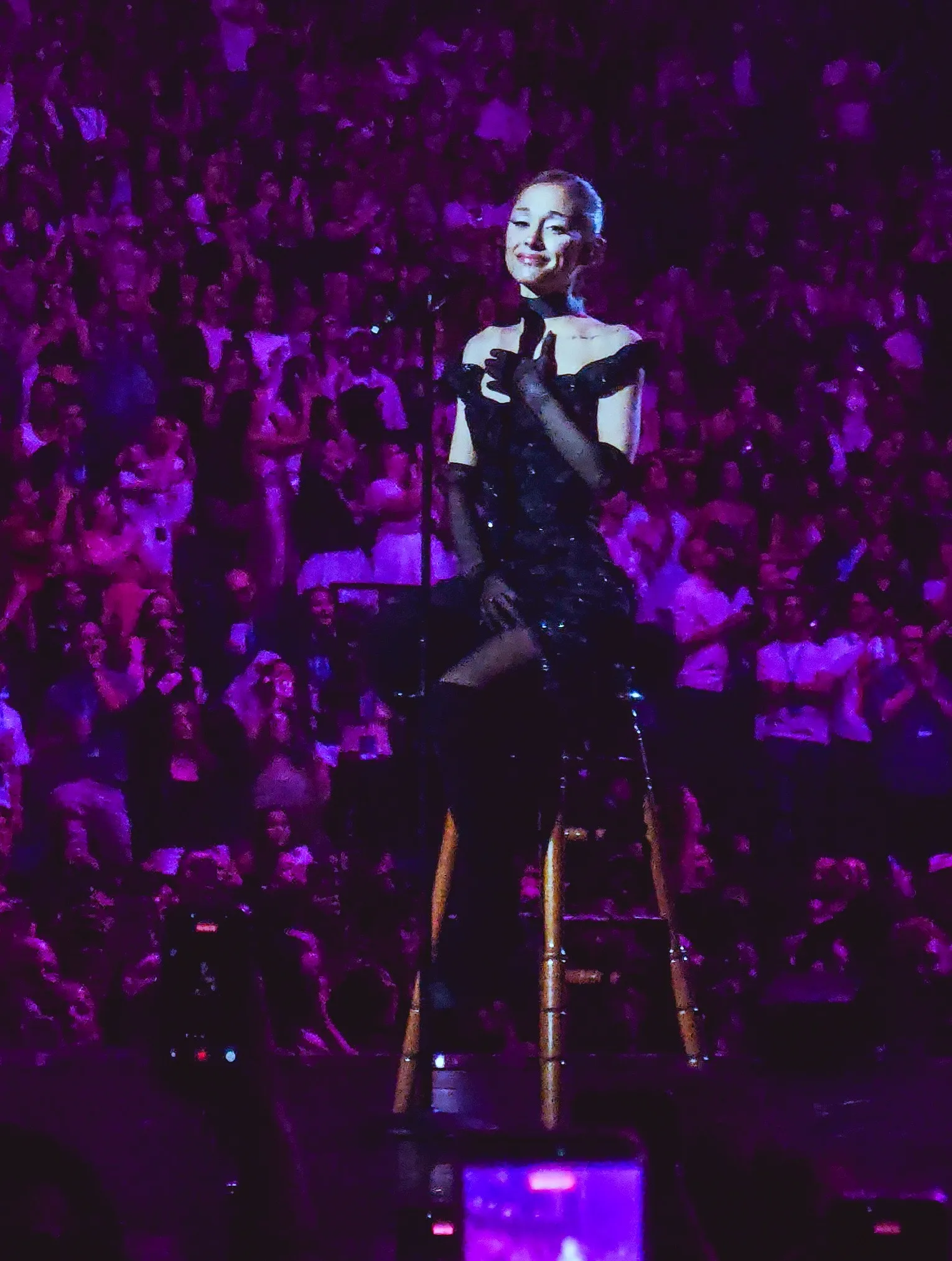Ariana Grande performing in a white gown at her final London tour show.