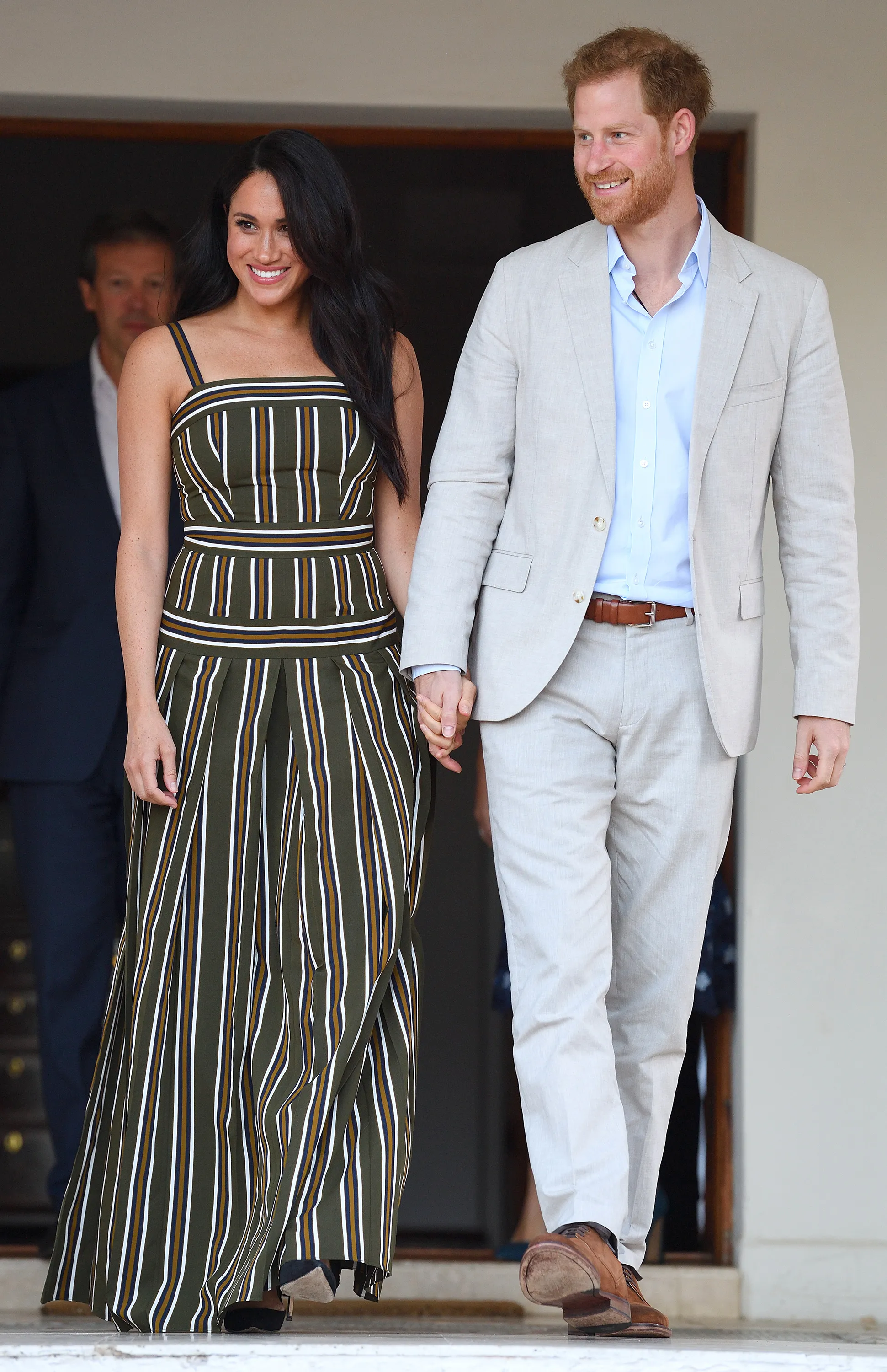 Meghan Markle and Prince Harry holding hands.