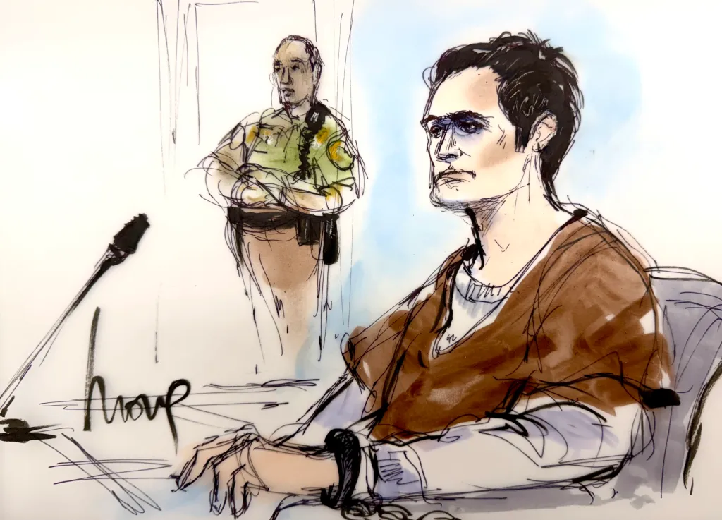 Courtroom sketch of Nick Reiner in a brown tunic, handcuffed, with a police officer behind him.