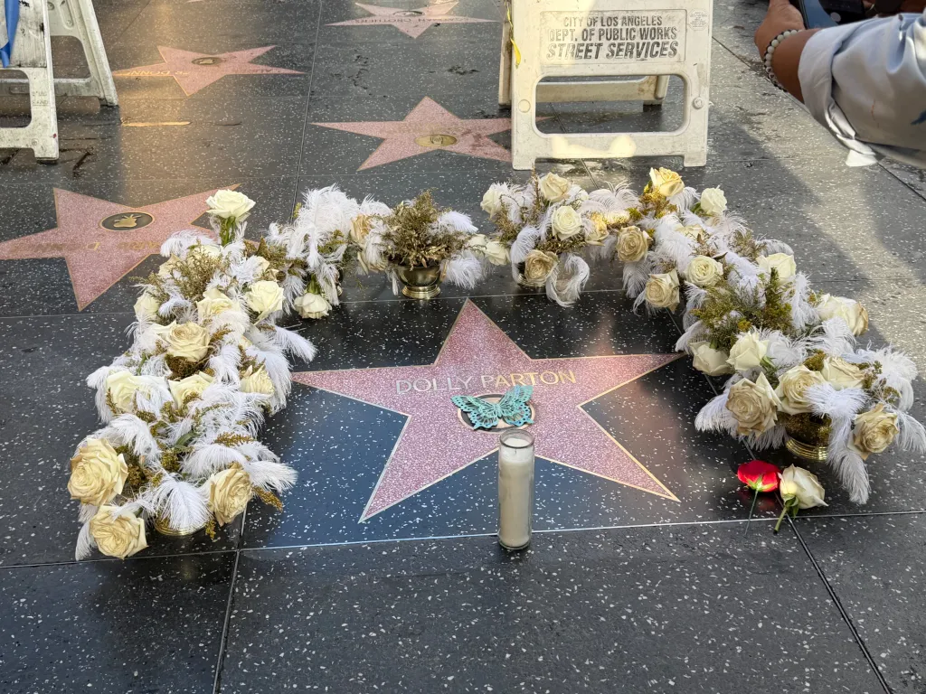 The Dolly Parton Hollywood Walk of Fame star, adorned with flowers and a candle, after being replaced following vandalism.