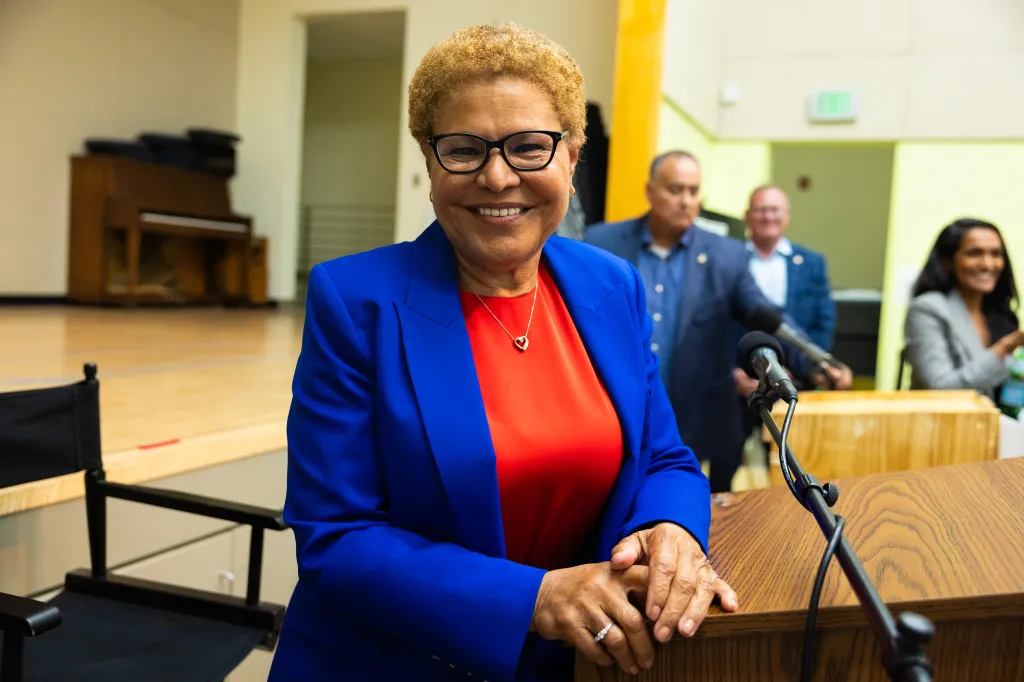 Los Angeles Mayor Karen Bass smiling at a podium after a general election debate.