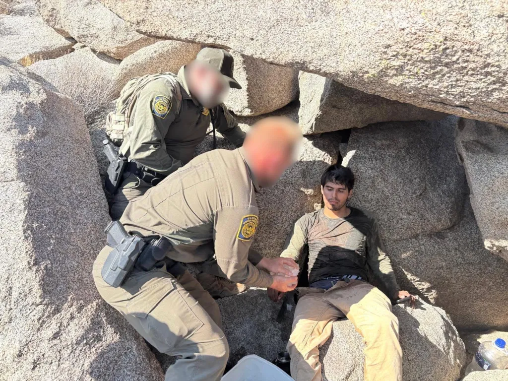 Two Border Patrol agents assisting a stranded man in the Jacumba Mountains.