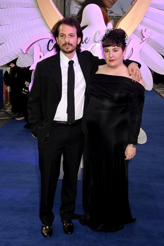 Luis Felber and Lena Dunham posing on the blue carpet.