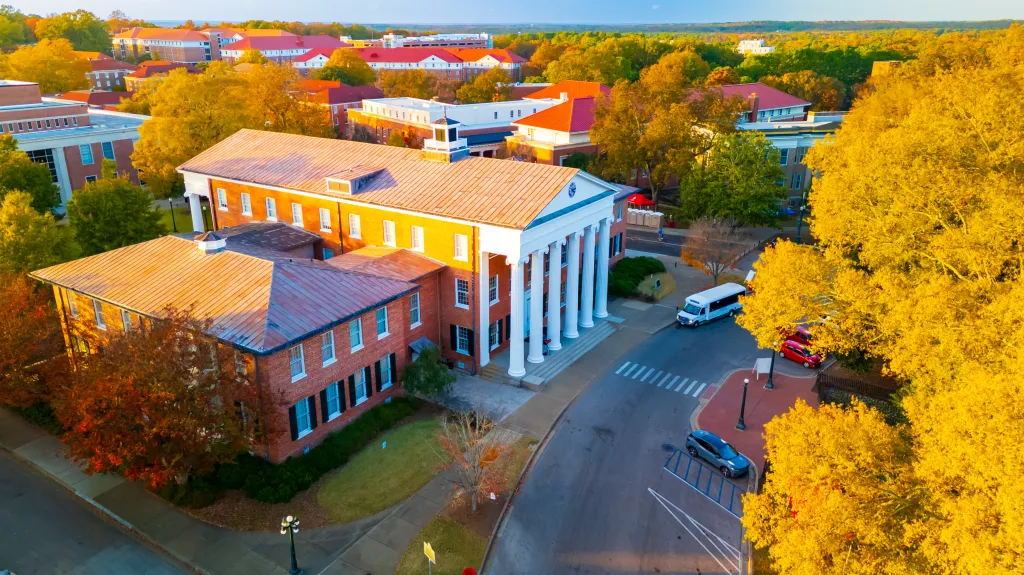 Aerial view of The Lyceum building at the University of Mississippi surrounded by autumn trees.