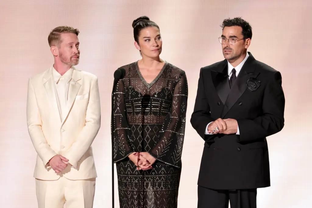 Macaulay Culkin, Annie Murphy, and Dan Levy speaking onstage at the 78th Primetime Emmy Awards.