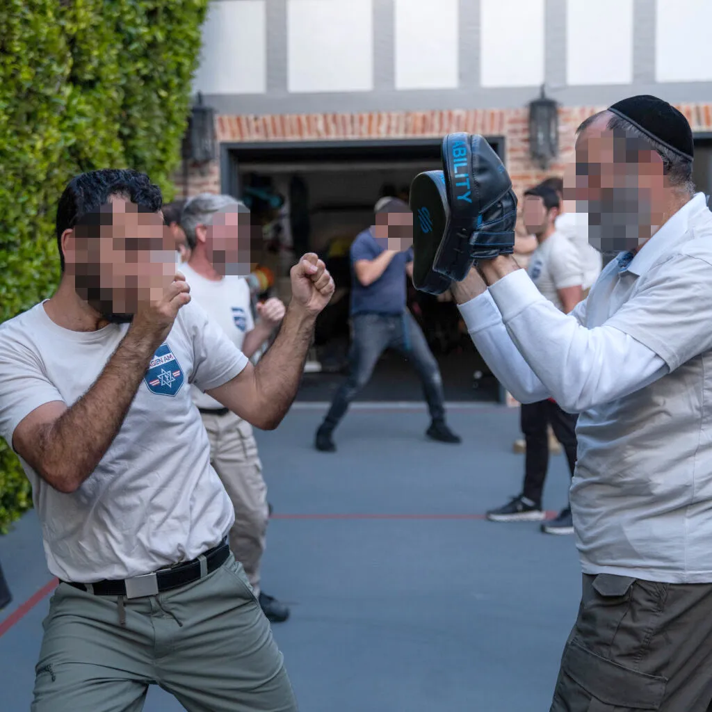 Two men in a group practicing self-defense.