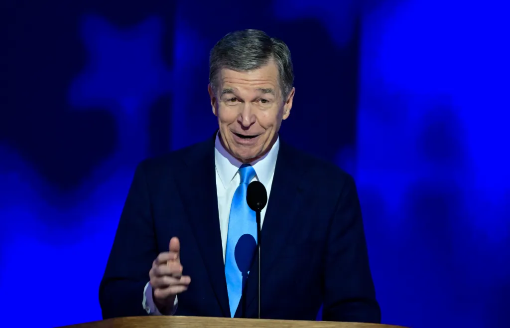 NC Gov. Roy Cooper making remarks at the 2024 Democratic National Convention had added a former Bloods gang member to a criminal justice task force during his term. 
