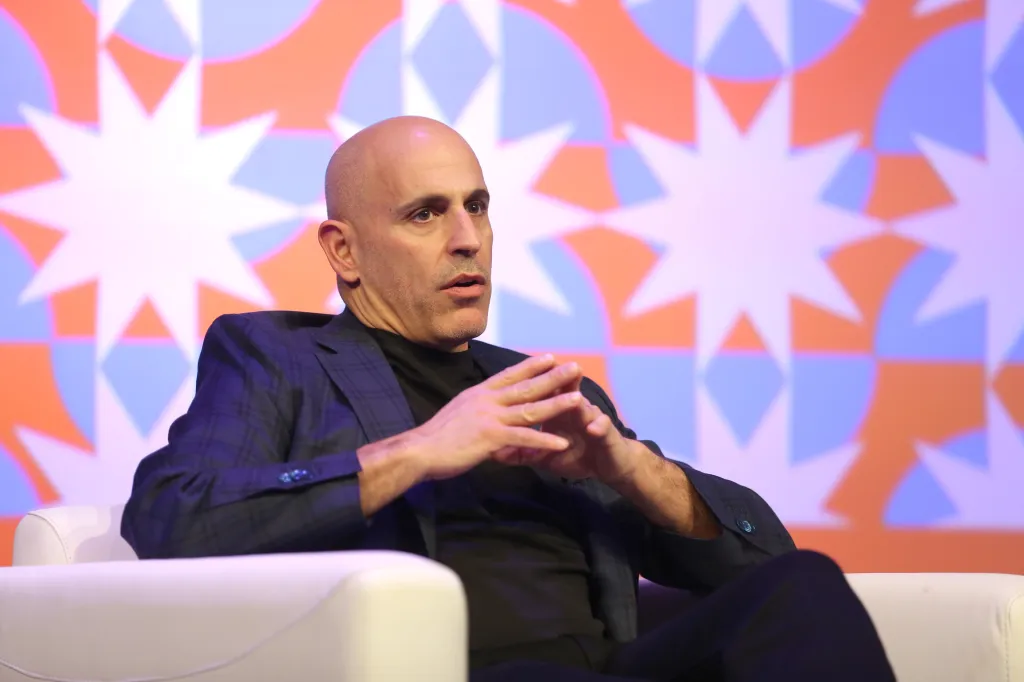 Marc Lore seated at a conference.