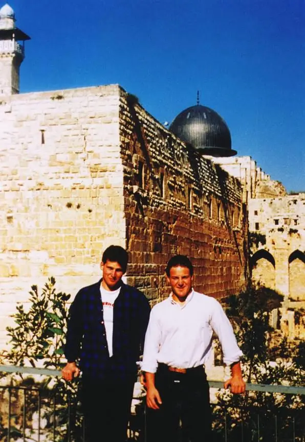 Marco Greenberg and Danny Lewin in Israel, with ancient stone buildings and a dome behind them.