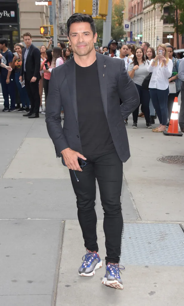 Mark Consuelos walking on a city street.