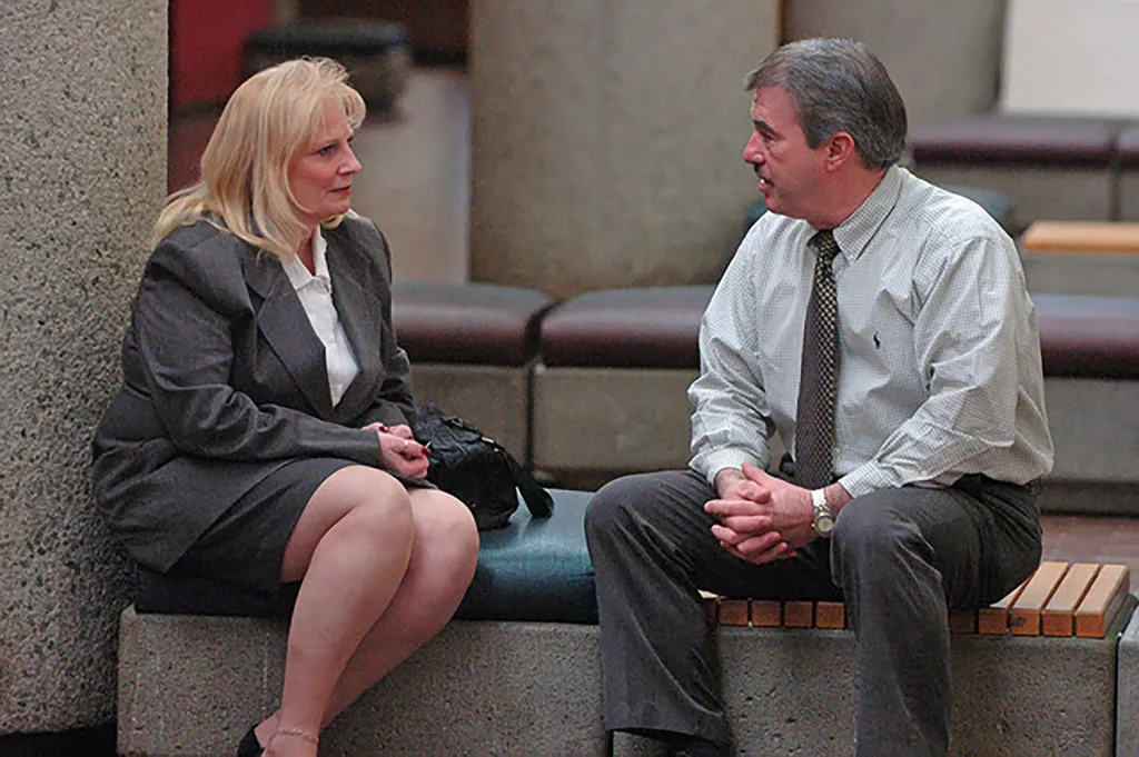 May Martinez and retired detective Randy York speaking at a courthouse.