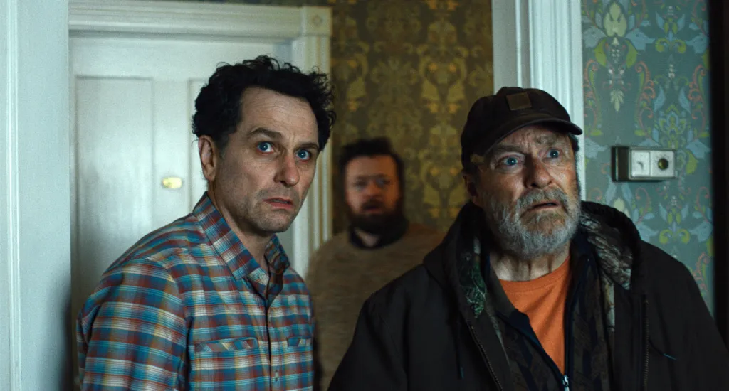 Matthew Rhys and Stephen Root look on in 