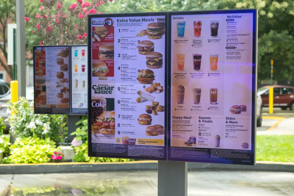 McDonald's drive-through menu boards display food items and prices.