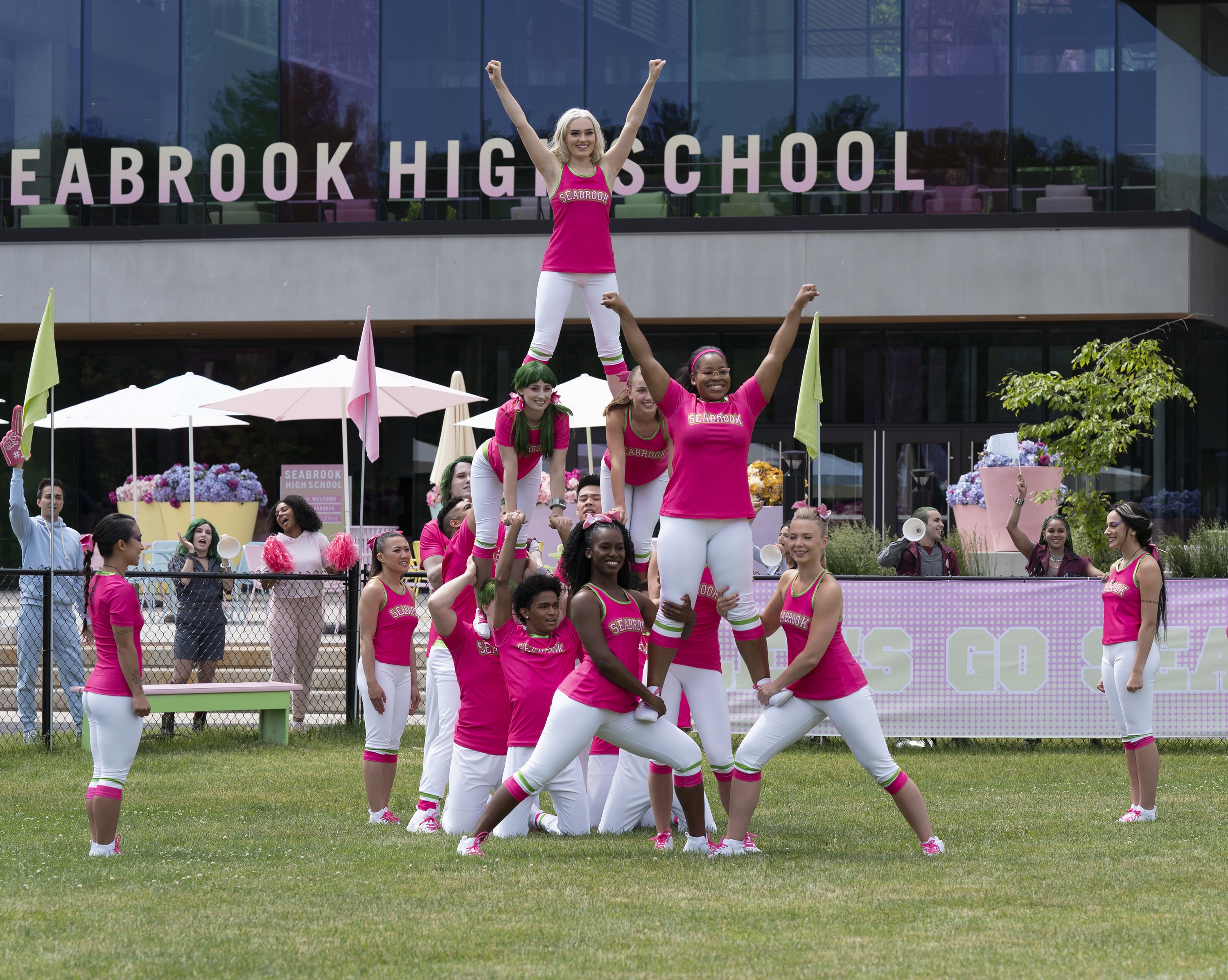 Cheerleaders from Seabrook High School forming a pyramid with Meg Donnelly at the top.
