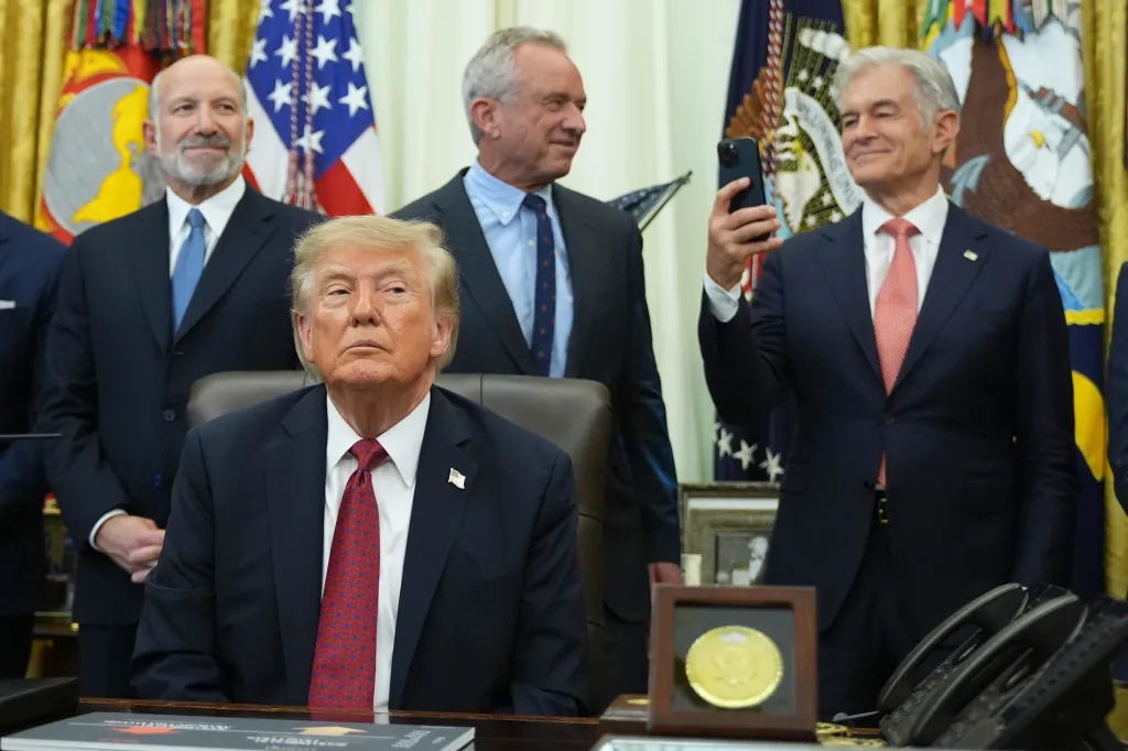 Donald Trump, Robert F. Kennedy Jr., Mehmet Oz, and Howard Lutnick attending an event about drug prices in the Oval Office.